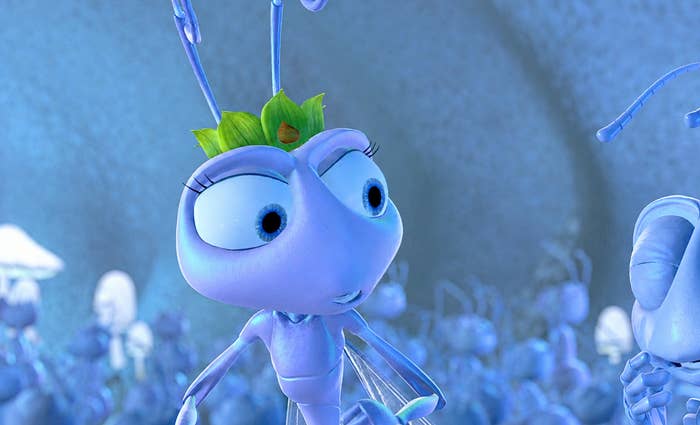 Animated ant wearing a small crown, looking thoughtful. Scene from a family-friendly movie