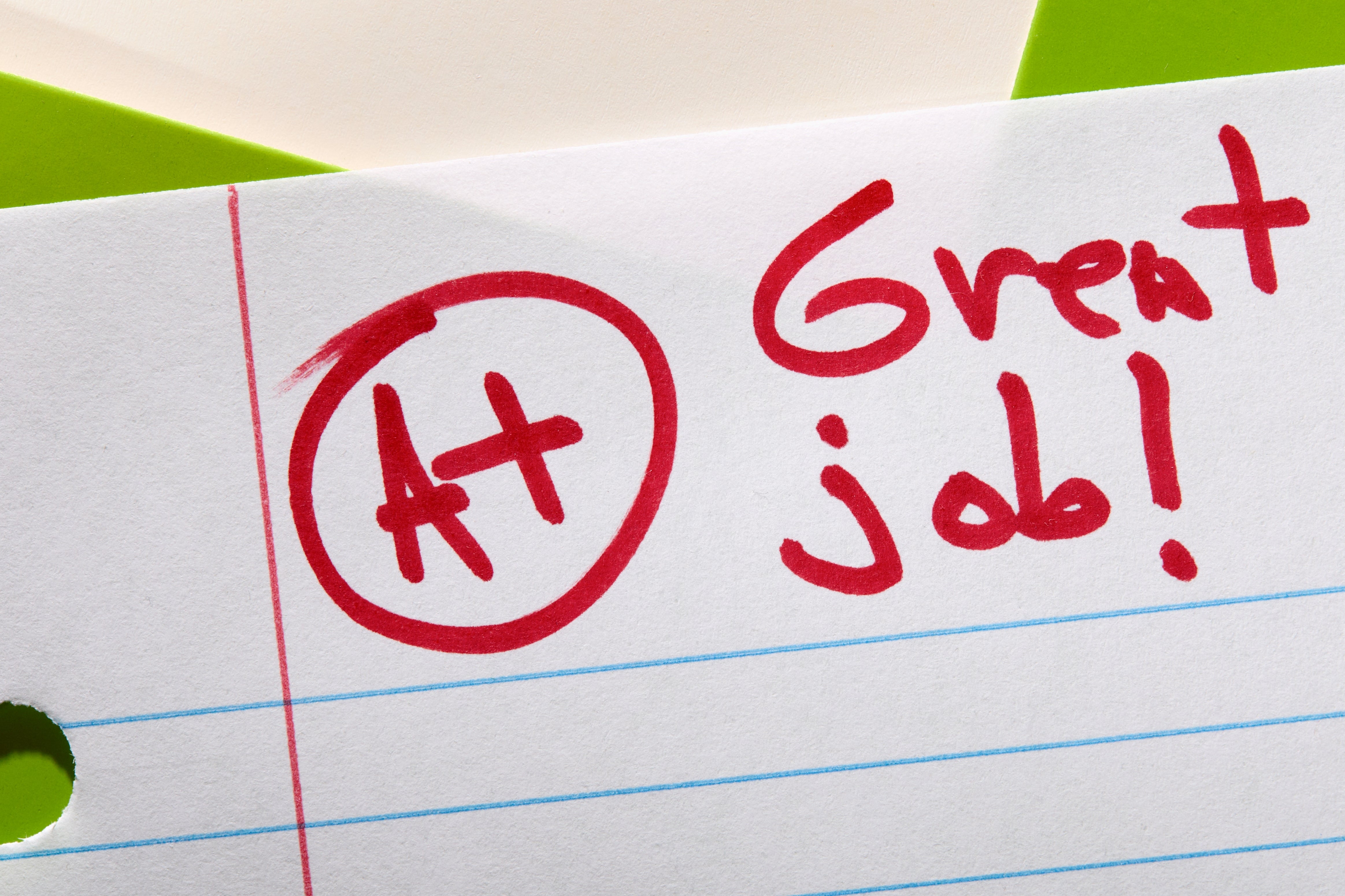 Paper with "A+ Great job!" written in red marker at the top