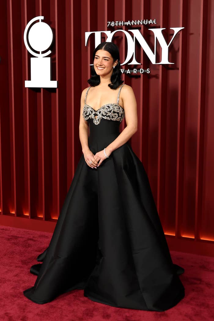 Charli D'Amelio in an elegant gown with intricate bodice detail poses on the red carpet at the 78th Annual Tony Awards