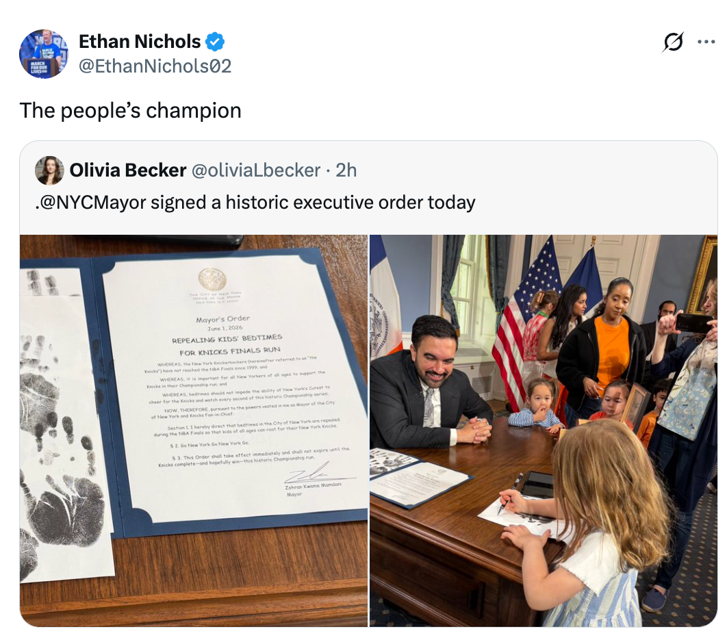 Tweet of a politician  signing a historical  enforcement  order, with attached photograph  of a politician  with children, documents, and an assemblage  successful  an authoritative  setting