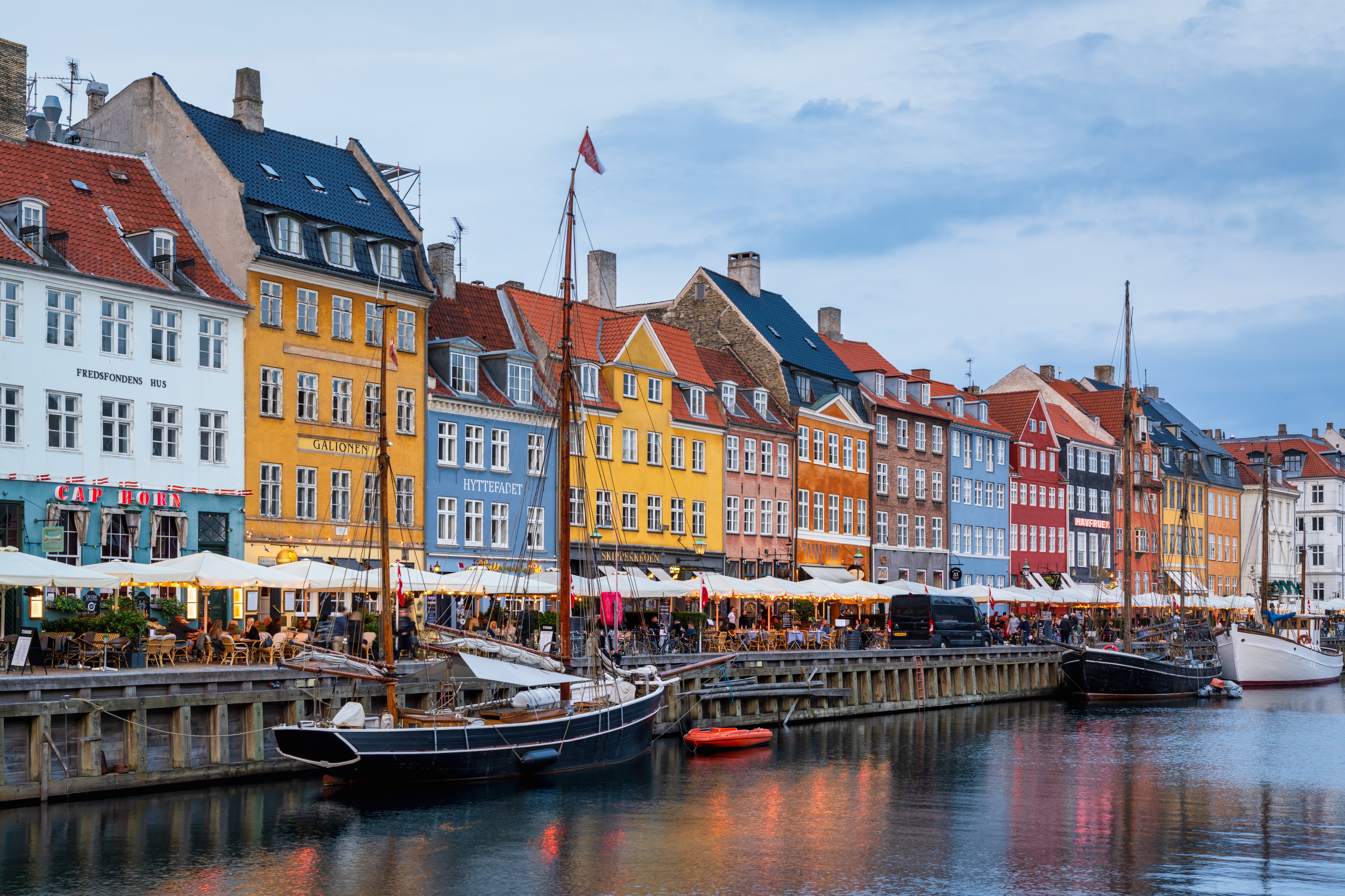 Scenic presumption    of Nyhavn, Copenhagen's historical  harbor, featuring colorful historical  buildings, docked boats, and lively waterfront cafes