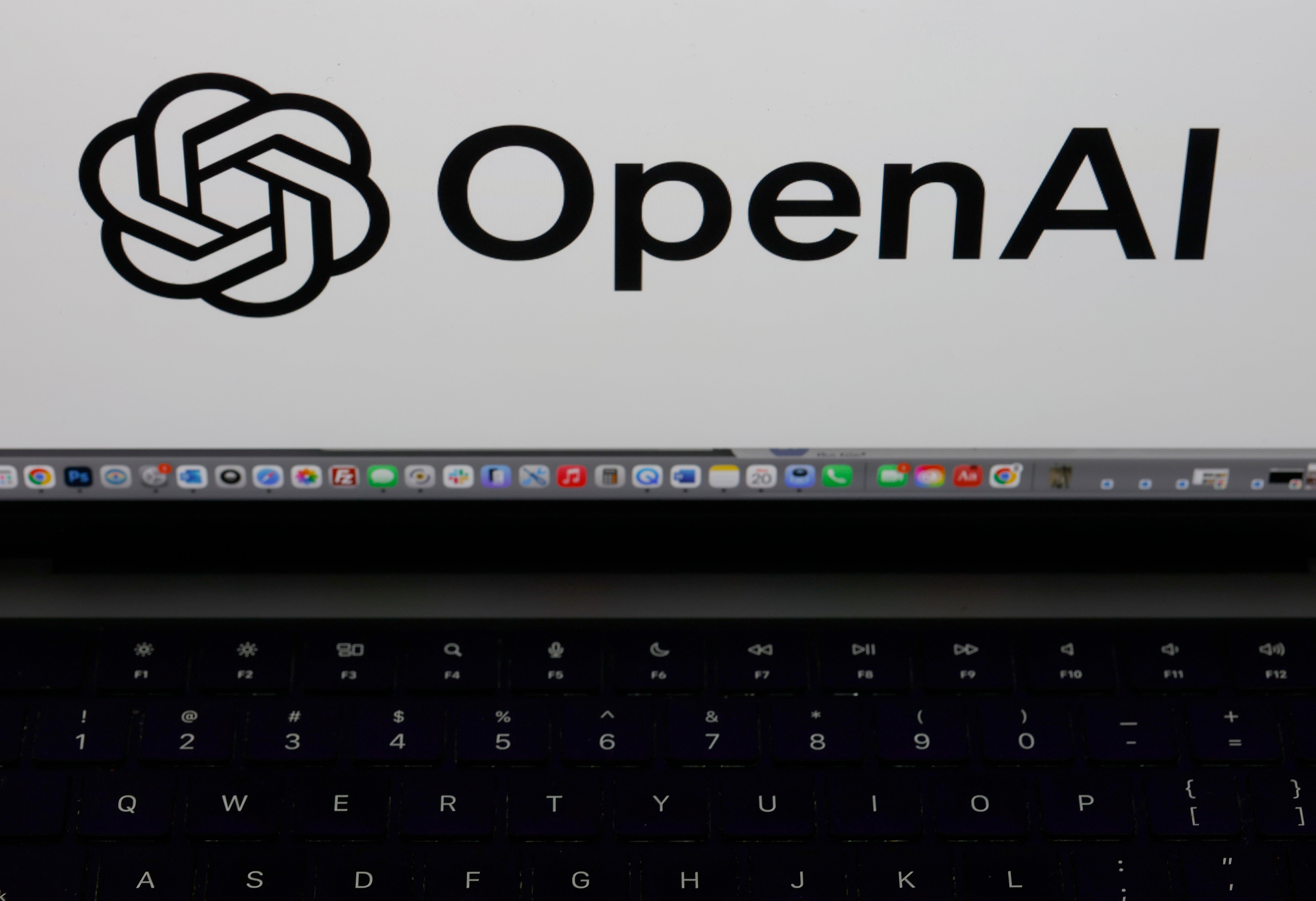 OpenAI logo displayed connected  a machine  surface  supra  a keyboard
