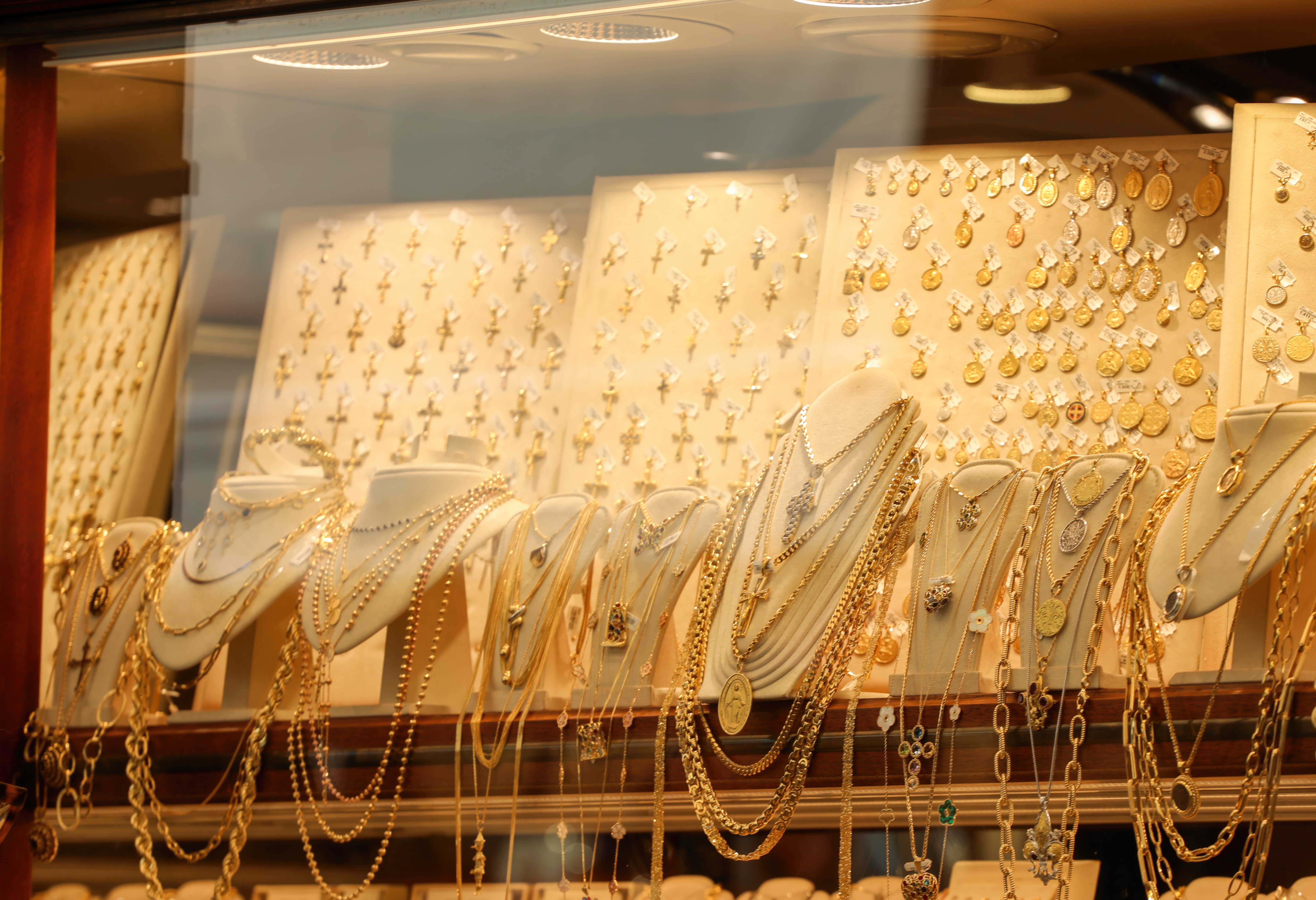 Jewelry store   show  with assorted  necklaces, pendants, and earrings arranged connected  mannequins and boards