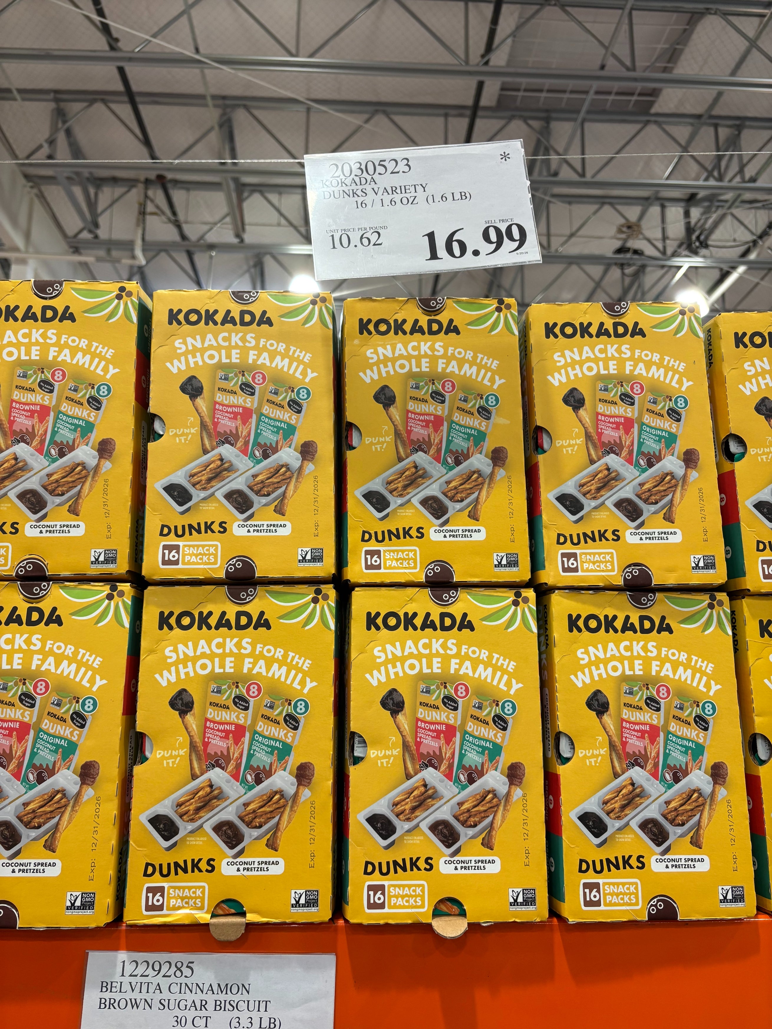 Boxes of Kokada snack packs displayed on a store shelf, promoting assorted flavors and snacks for families. Price is $16.99