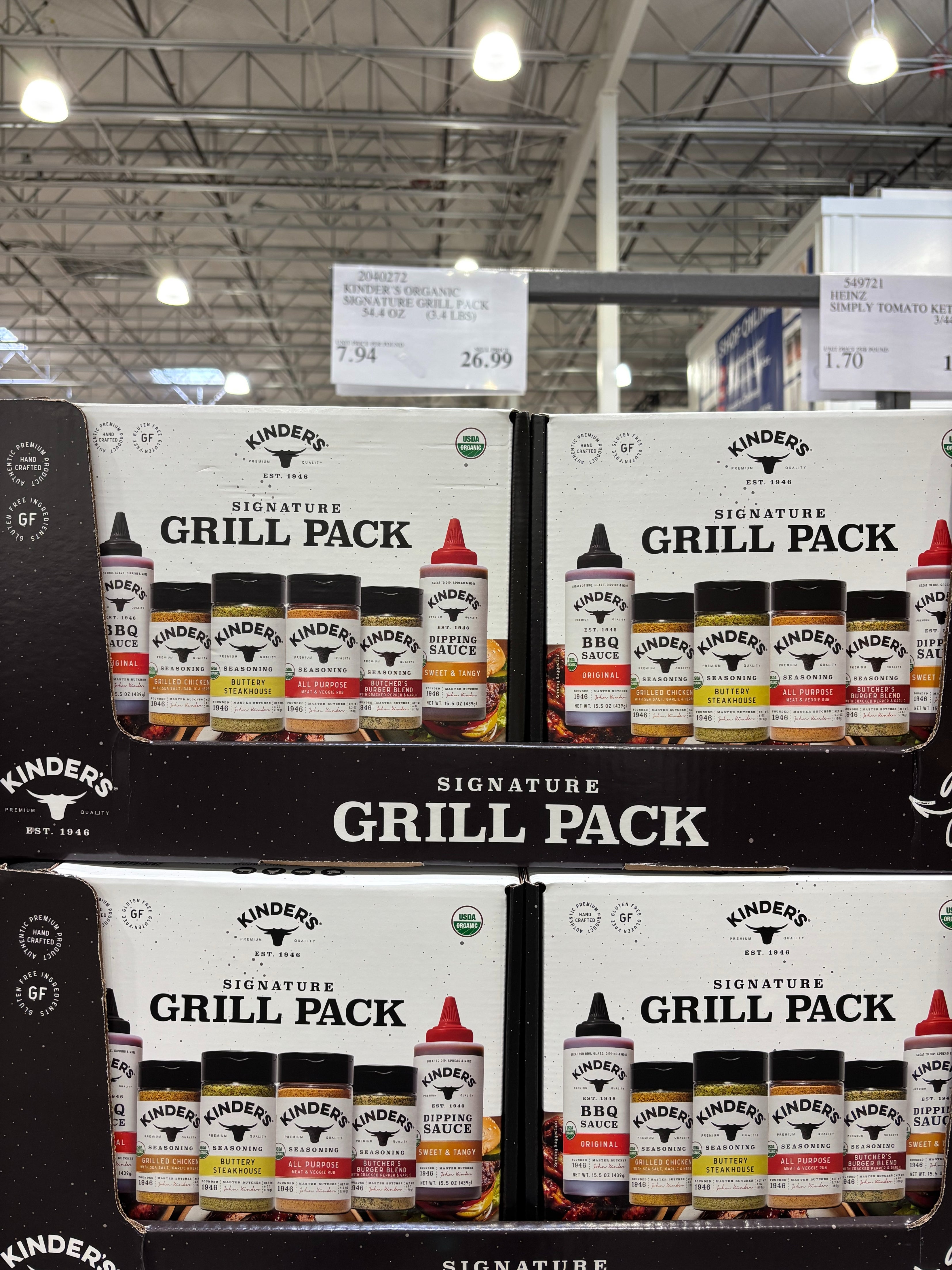 Display of Kinder's Signature Grill Pack including various sauces, positioned in a grocery store aisle