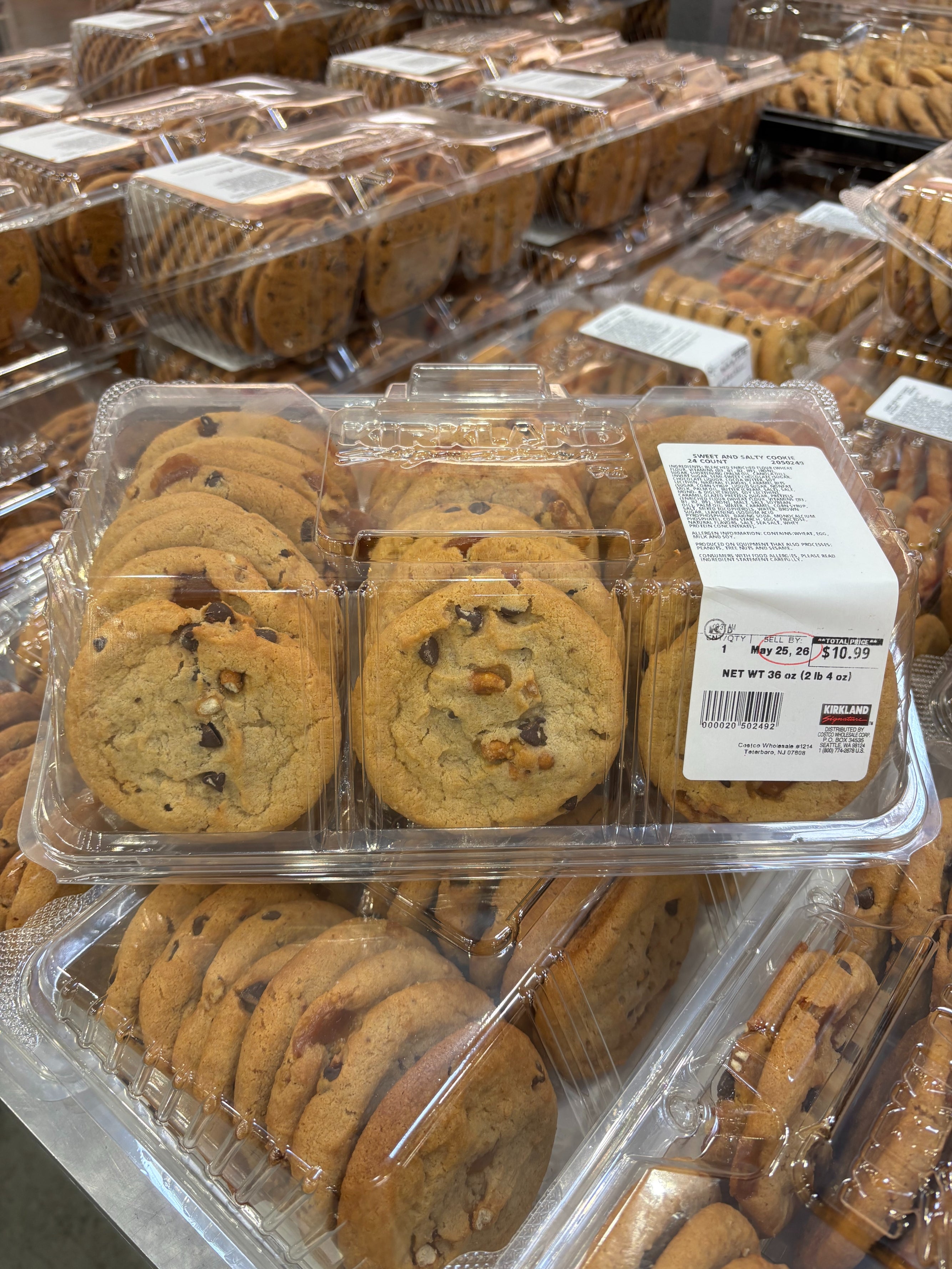 Packaged chocolate chip cookies displayed in a store, with a price tag of $10.99