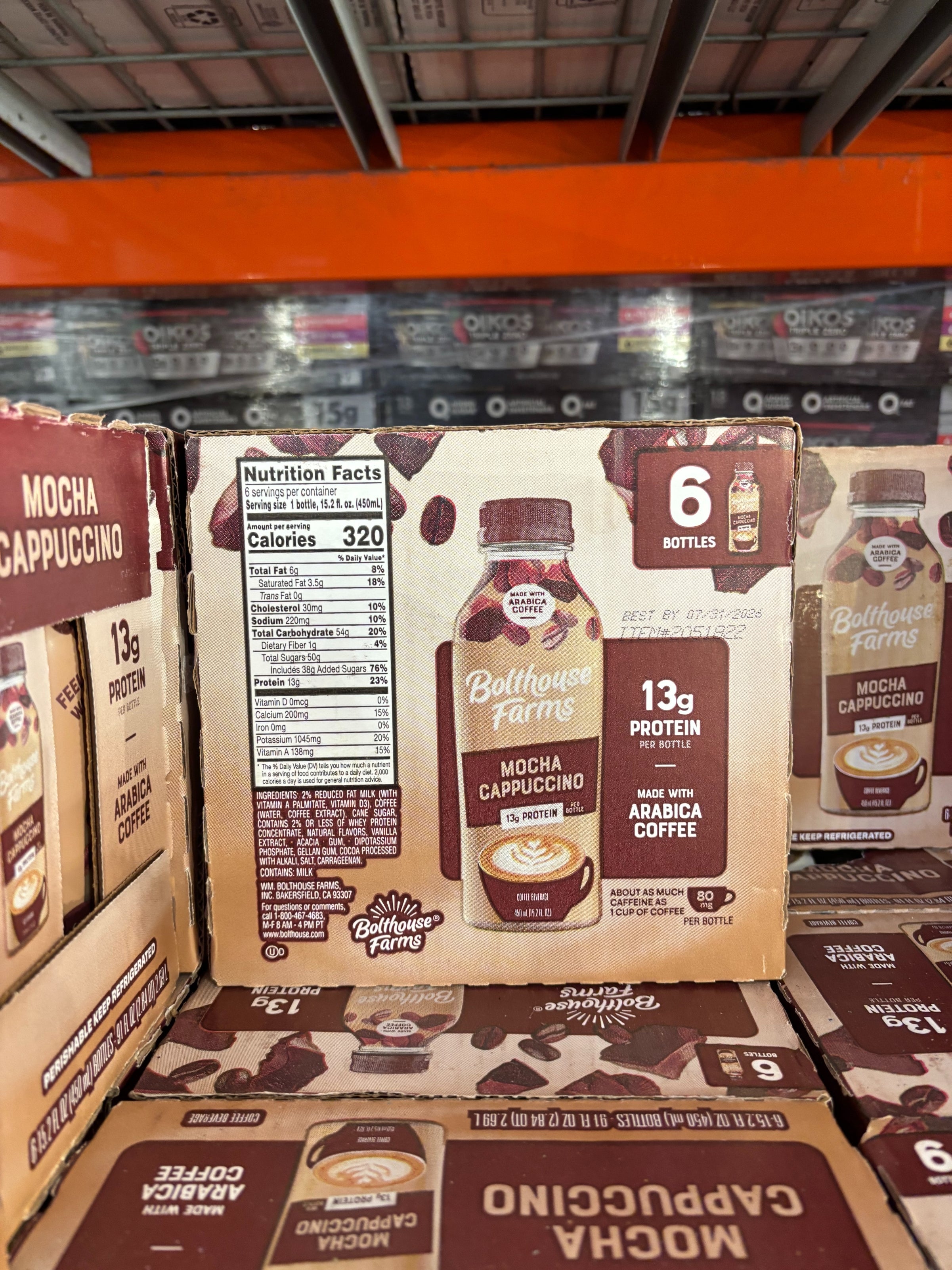 Box of Bolthouse Farms Mocha Cappuccino bottles on a store shelf, featuring nutrition facts and 13g protein label