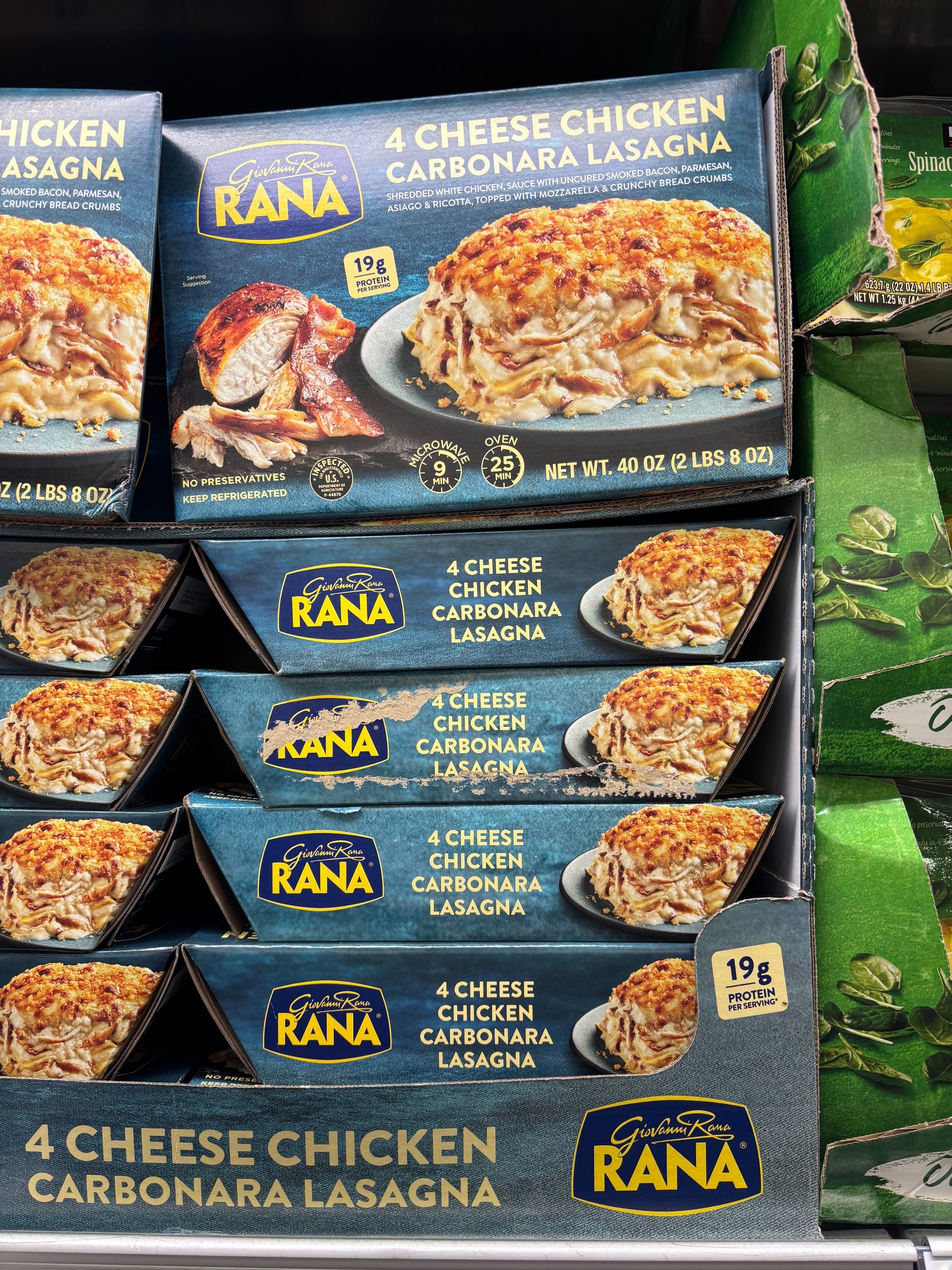 Boxes of Rana 4 Cheese Chicken Carbonara Lasagna stacked on a supermarket shelf, showing lasagna image and nutrition info