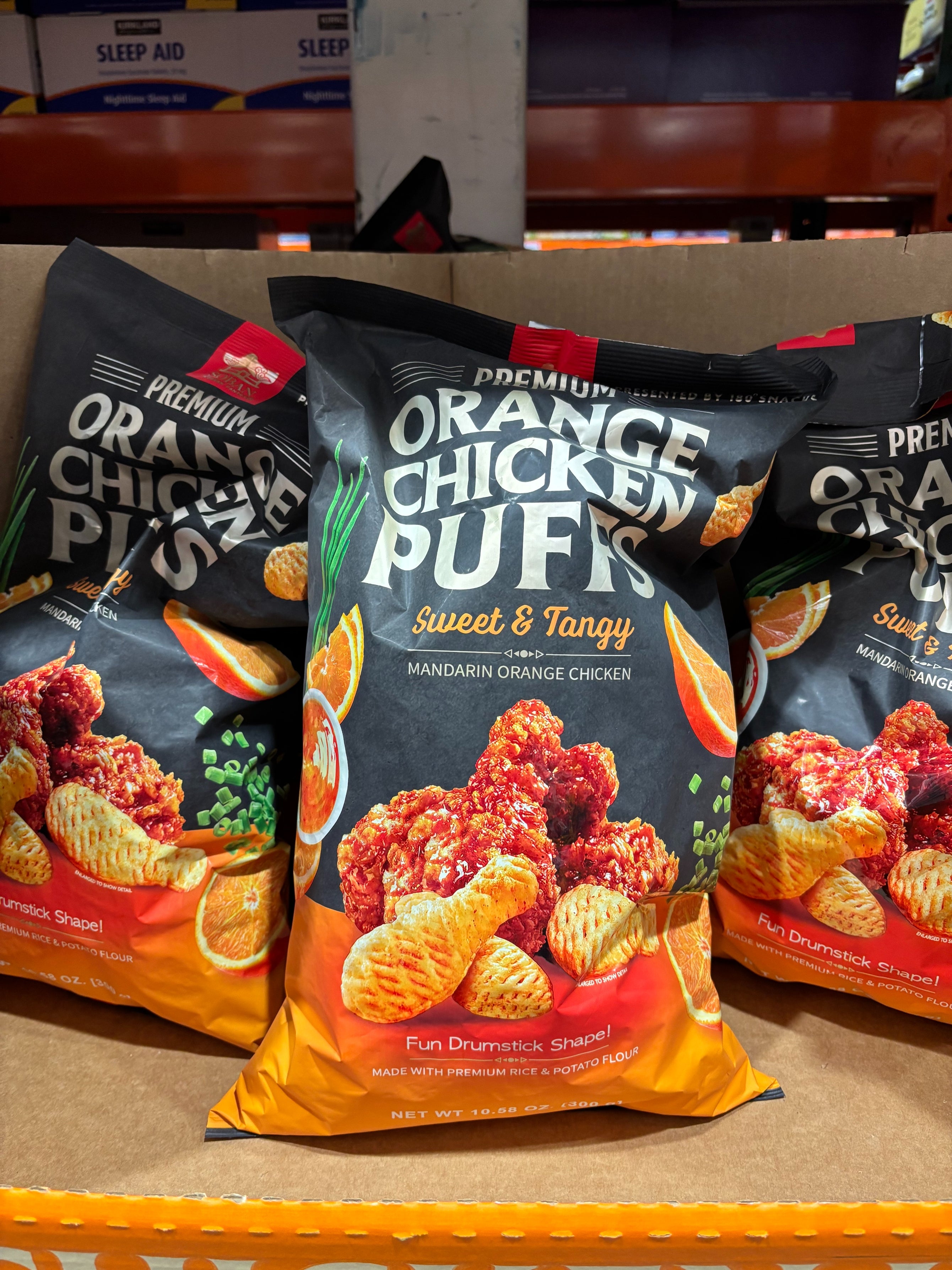 Bags of orange chicken-flavored snacks with sweet and tangy mandarin flavor displayed on a store shelf