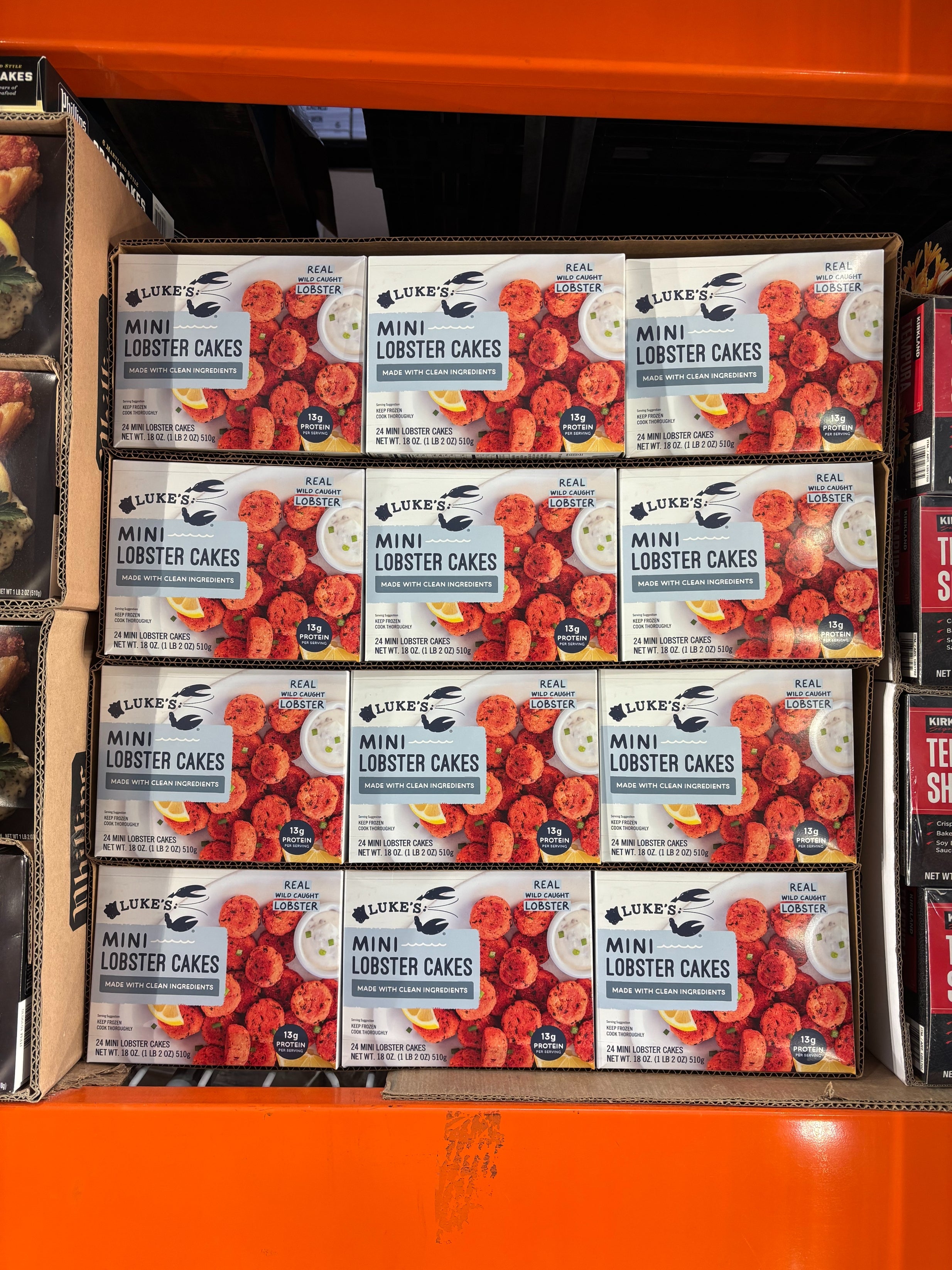 Boxes of Luke's Mini Lobster Cakes stacked on a store shelf