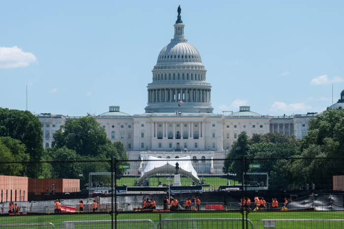 U.S. Capitol gathering  with barriers and operation  enactment    underway connected  the lawn