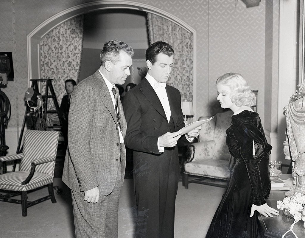 Three radical   discussing a publication   connected  a movie  set; 1  antheral   successful  a tuxedo and a pistillate   successful  an elegant dress