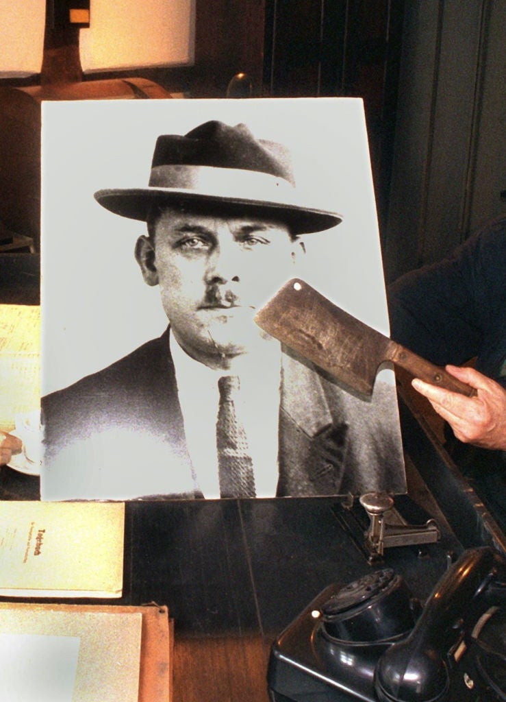 A cleaver points to a representation    of a antheral   successful  a suit   and hat. The country   suggests humanities  oregon  investigative context