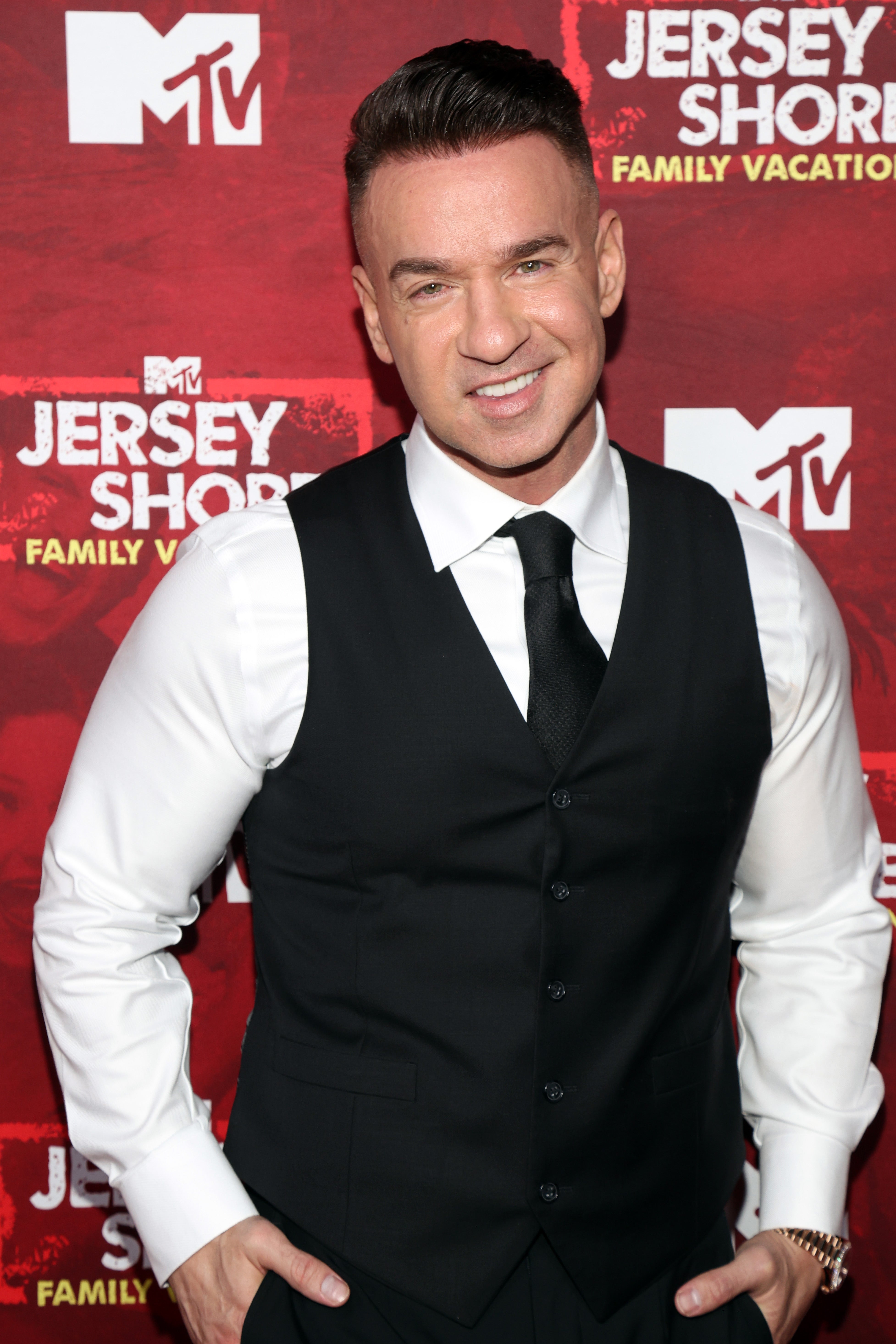 Person successful a ceremonial achromatic vest and achromatic garment connected an MTV reddish carpet event