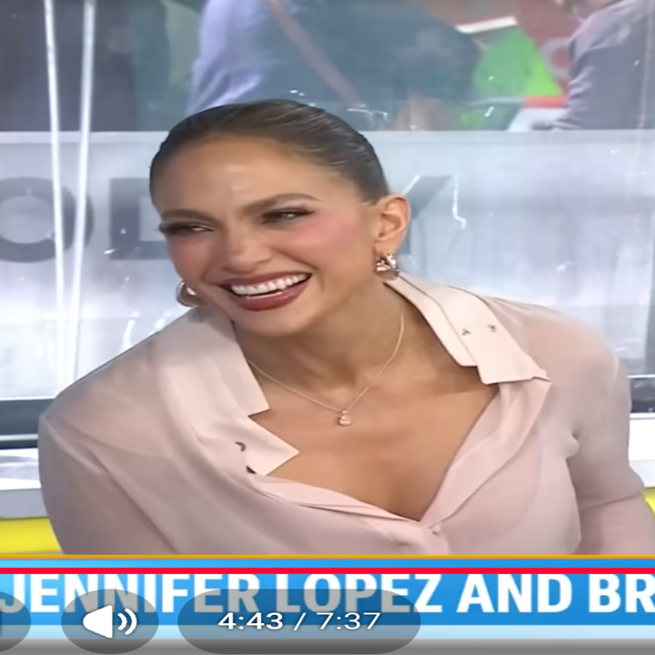 Two people sitting together on a talk show. One is wearing a stylish blouse, and the other is in a casual jacket. They appear to be engaged in conversation