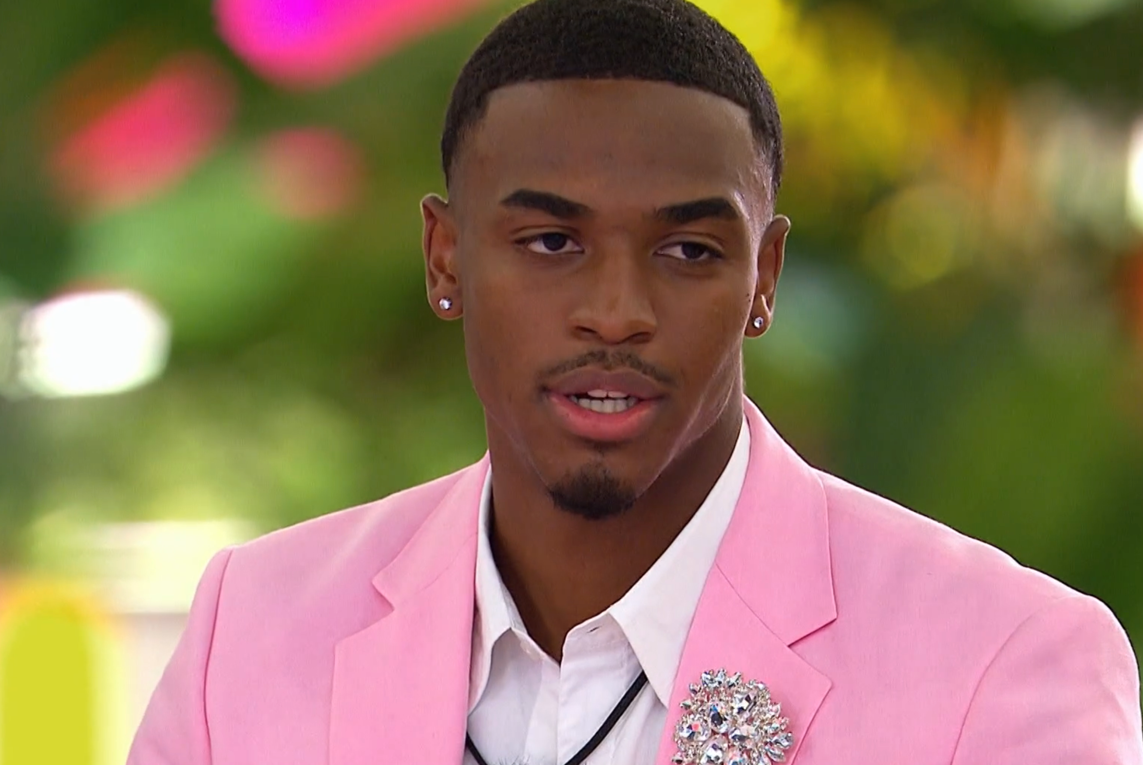 Person successful  a stylish suit   with floral lapel pin, speaking outdoors