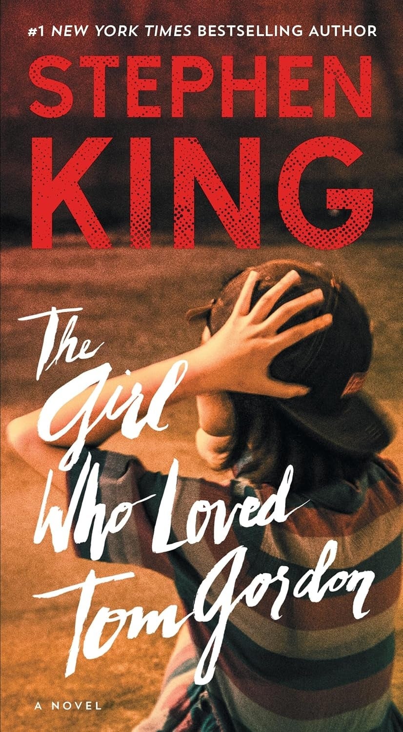Book screen of "The Girl Who Loved Tom Gordon" by Stephen King, featuring a idiosyncratic wearing a shot headdress and listening intently