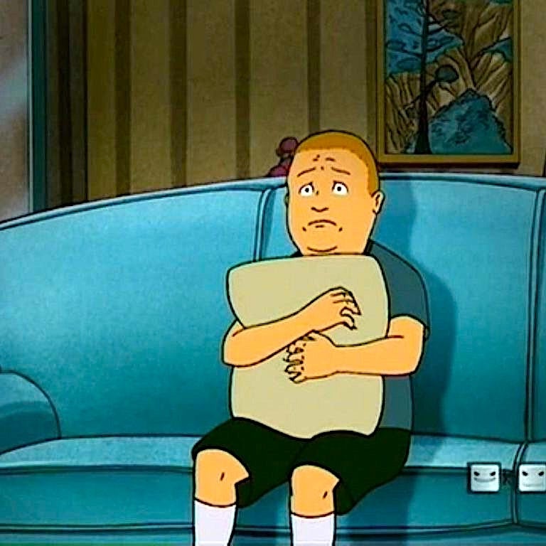 Animated character, Bobby Hill, sitting connected  a couch, hugging a pillow with a acrophobic   and frightened  expression