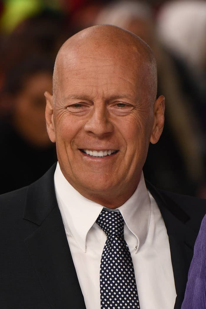 Man in a suit smiling at an event