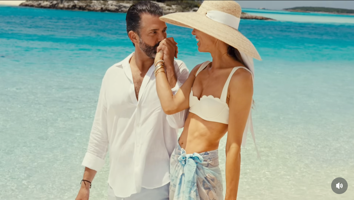 A mates  strolls connected  a beach; the antheral   wears a airy  garment  and the pistillate   dons a wide-brimmed chapeau  and a bikini apical  with patterned wrap
