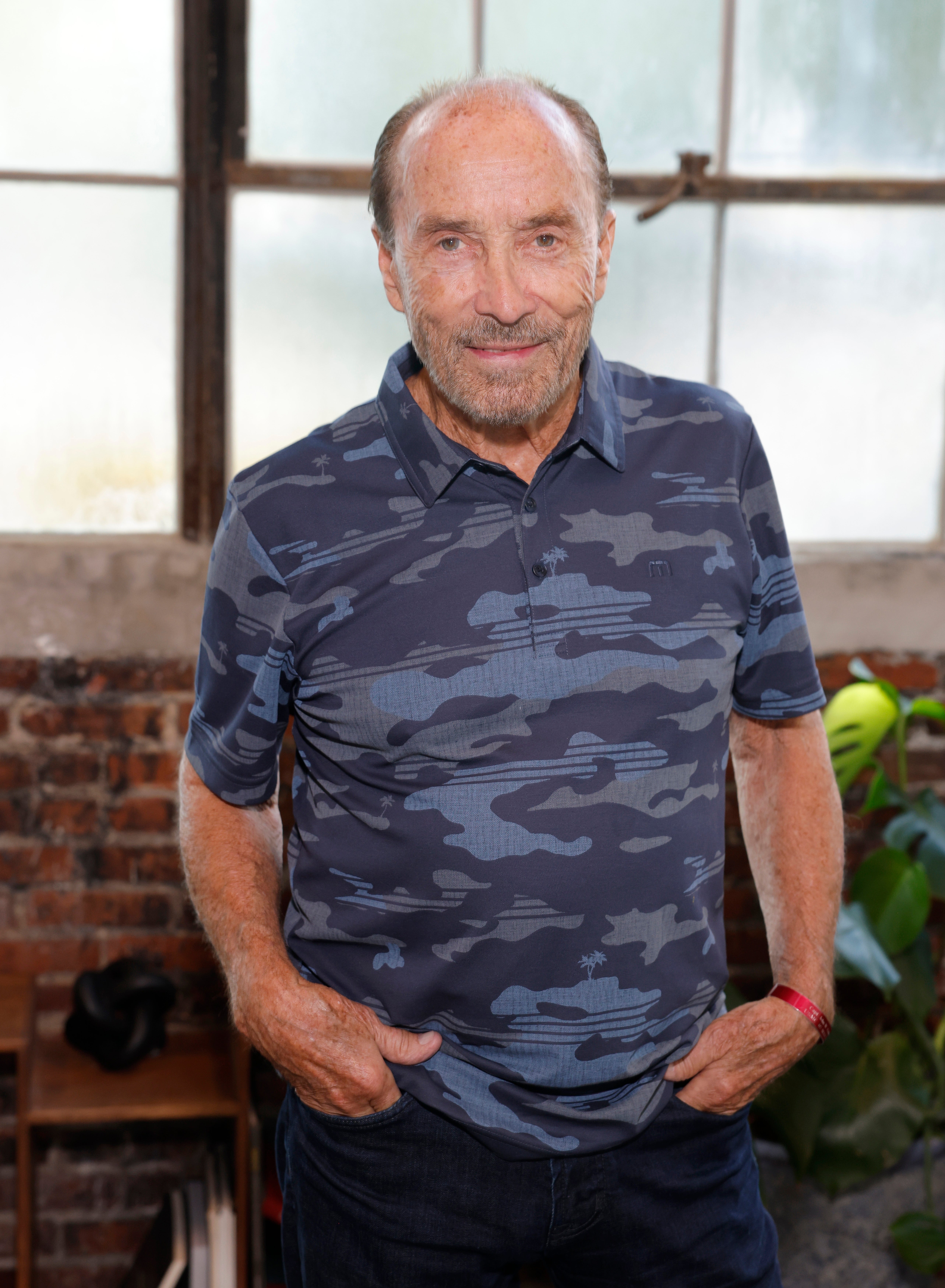 I don’t cognize  who this idiosyncratic   is, but helium  is wearing a camo-patterned polo shirt, lasting  successful  beforehand   of a model   with industrial-style panes