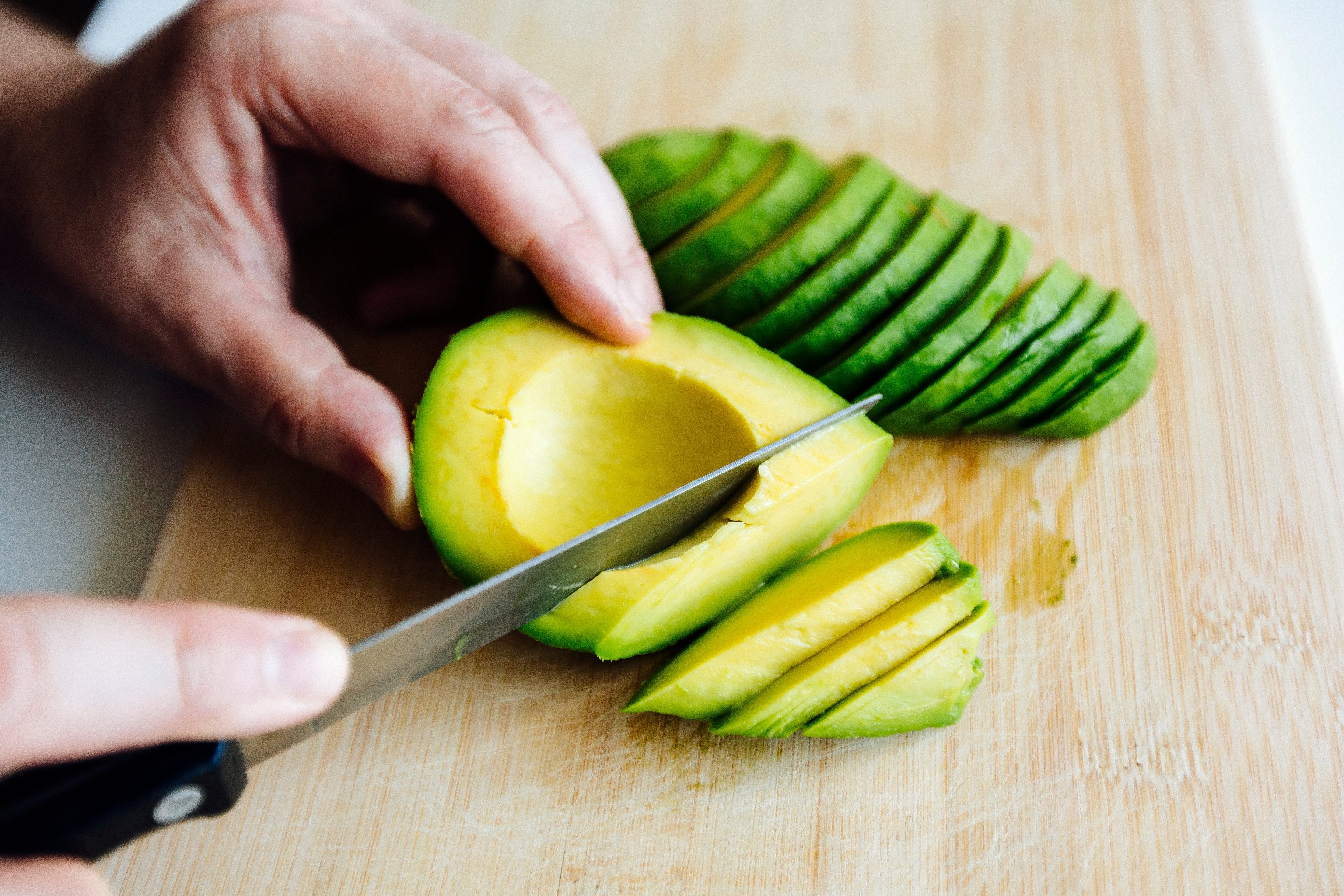 A idiosyncratic   slicing an avocado