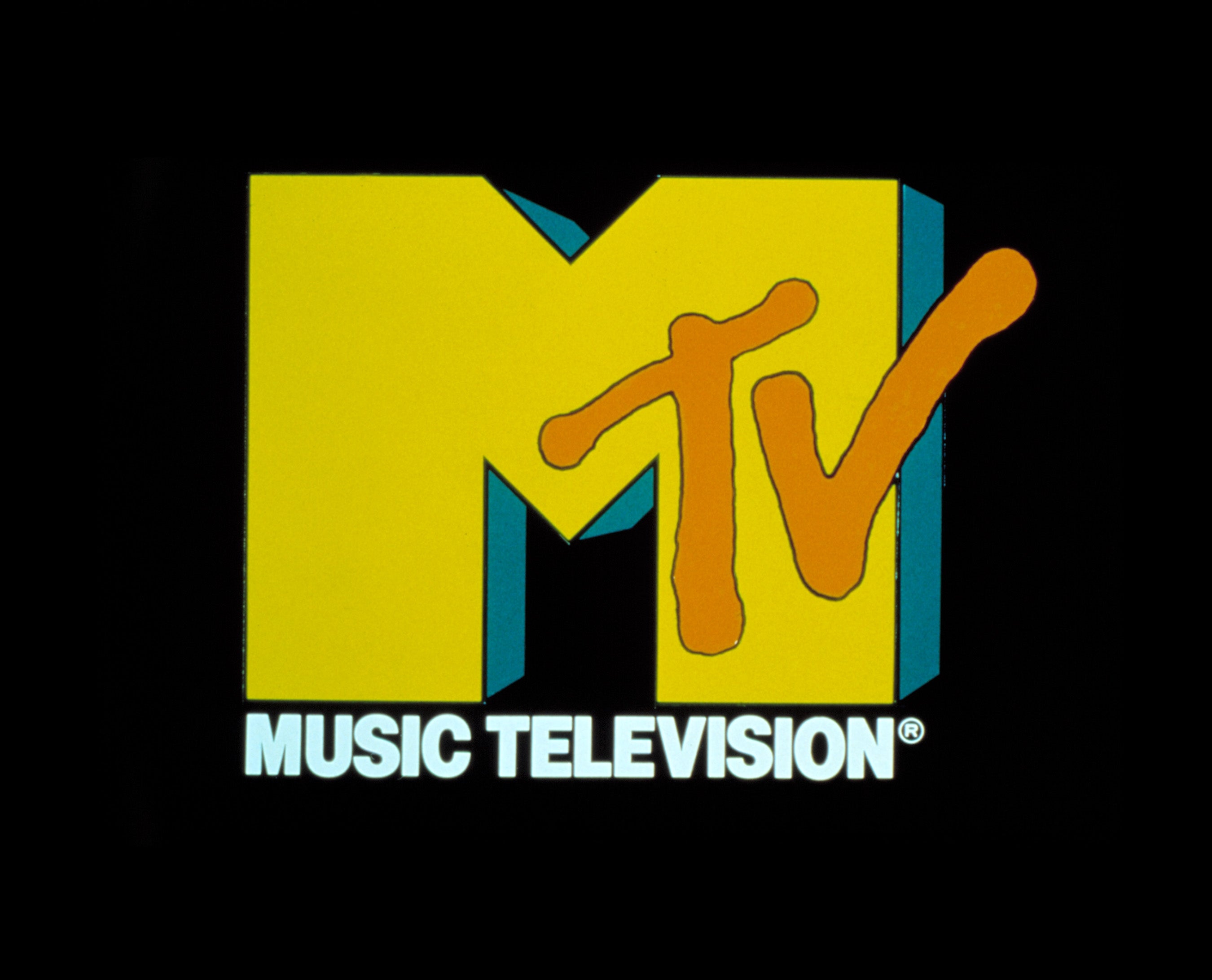 MTV logo with ample yellowish "M" and orangish "TV" connected a achromatic background, with "Music Television" written below