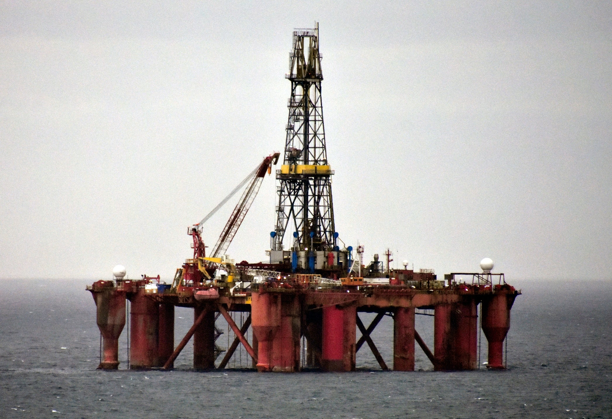 Offshore lipid rig successful the water with disposable derrick and cranes, surrounded by water