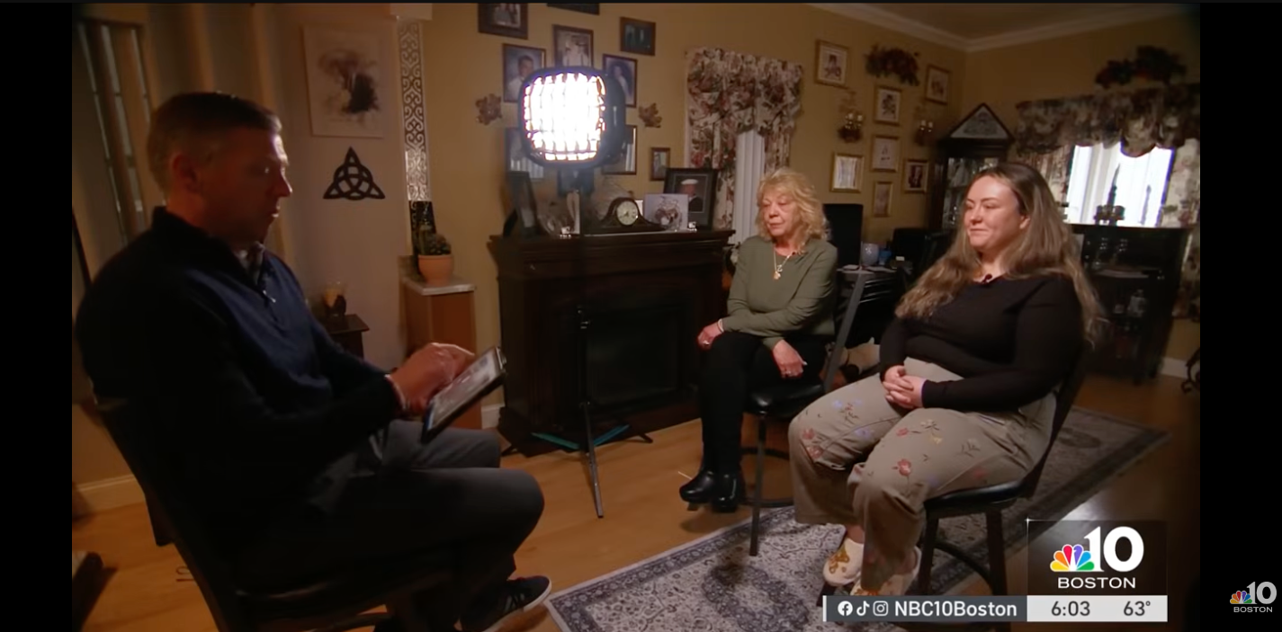 A antheral interviews 2 women seated successful a surviving country setting, with a camera airy successful the background