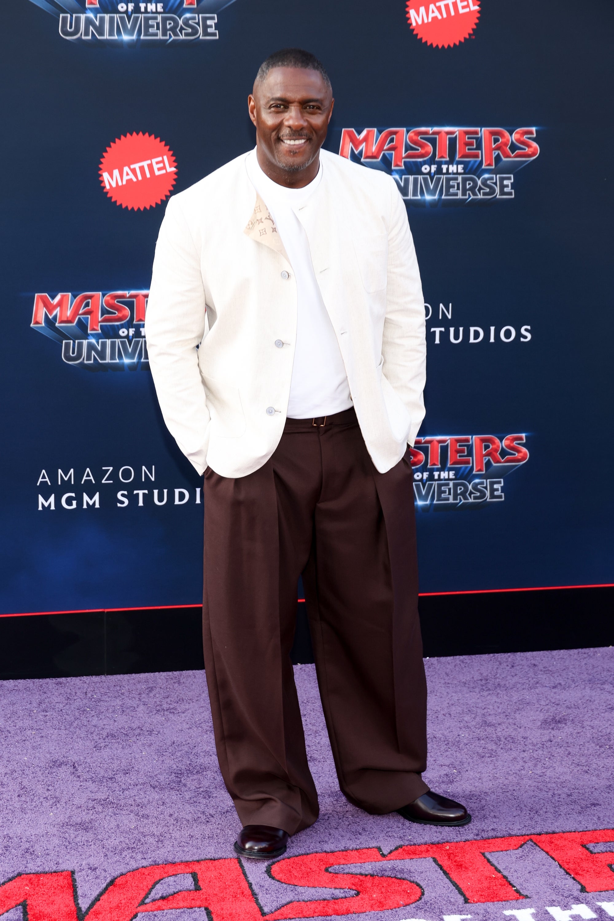 Person successful casual chic outfit with a achromatic blazer and wide brownish pants astatine a premiere lawsuit backdrop