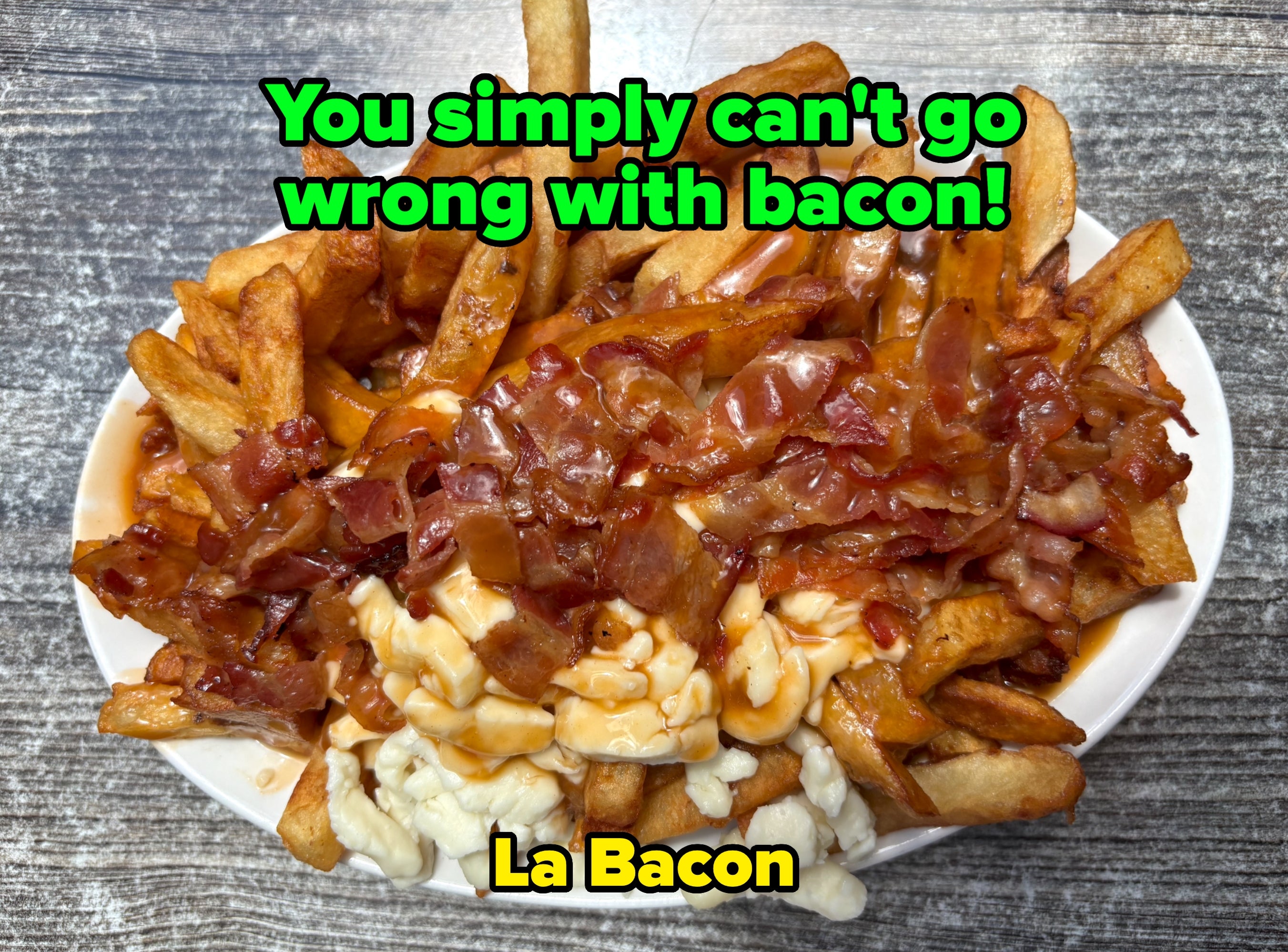 A crockery of fries topped with gravy, bacon, and food curds, resembling poutine, connected a textured array surface