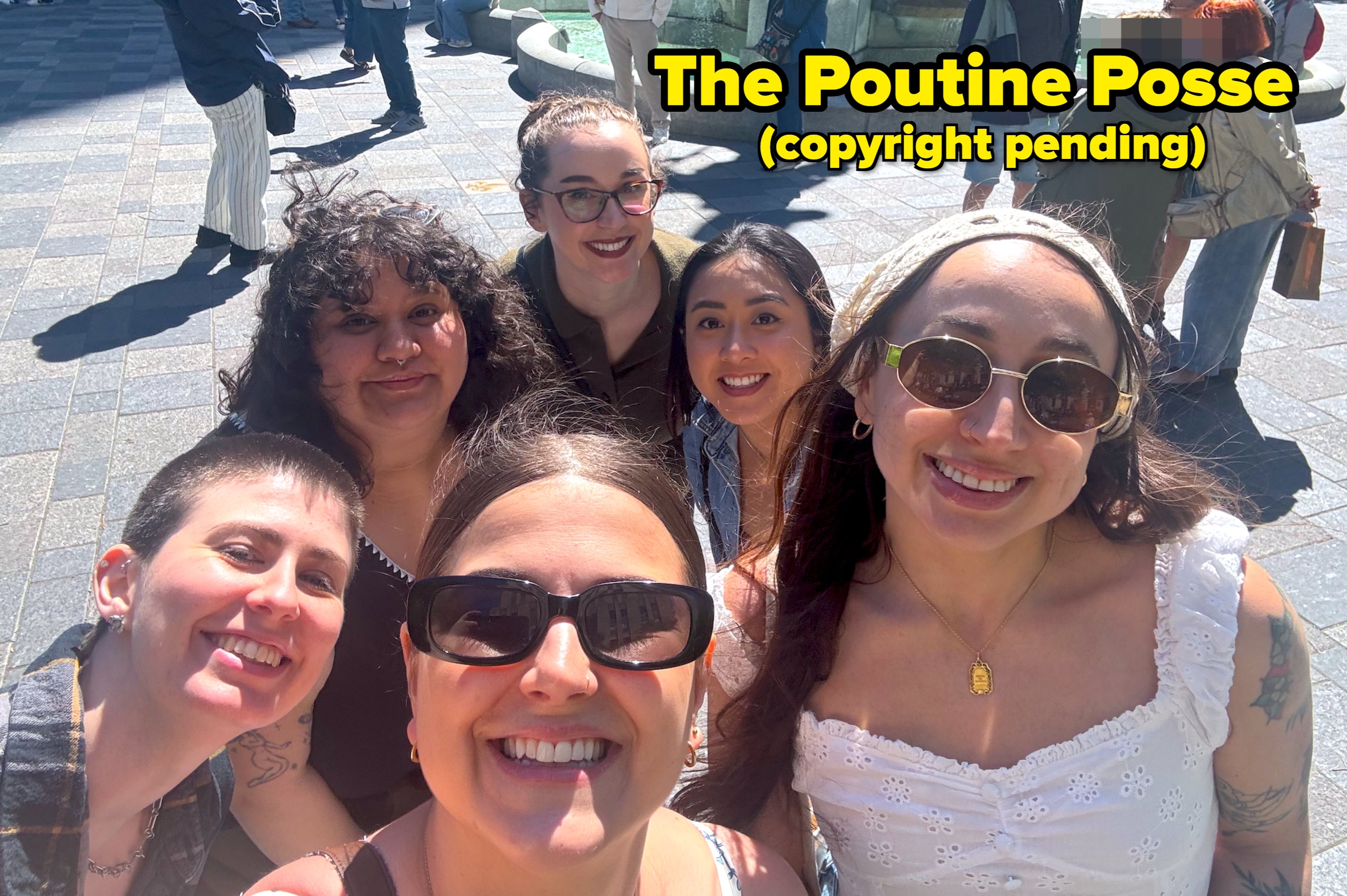 Group of six smiling friends taking a selfie successful beforehand of a fountain successful an outdoor plaza