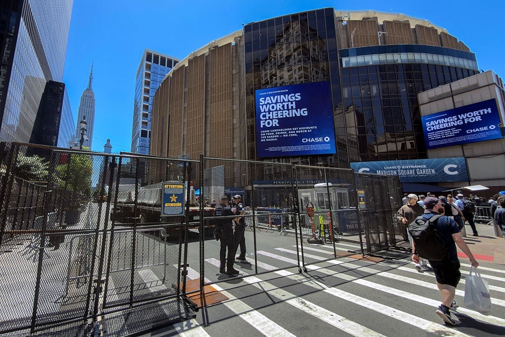 People walking adjacent Madison Square Garden, New York, with ample "Savings Worth Cheering For" Chase advertisements connected display