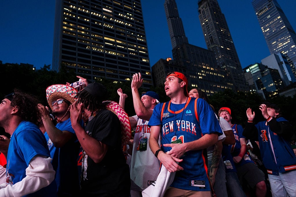 Fans successful New York jerseys excitedly ticker a crippled connected a ample surface outdoors, surrounded by gangly metropolis buildings astatine night