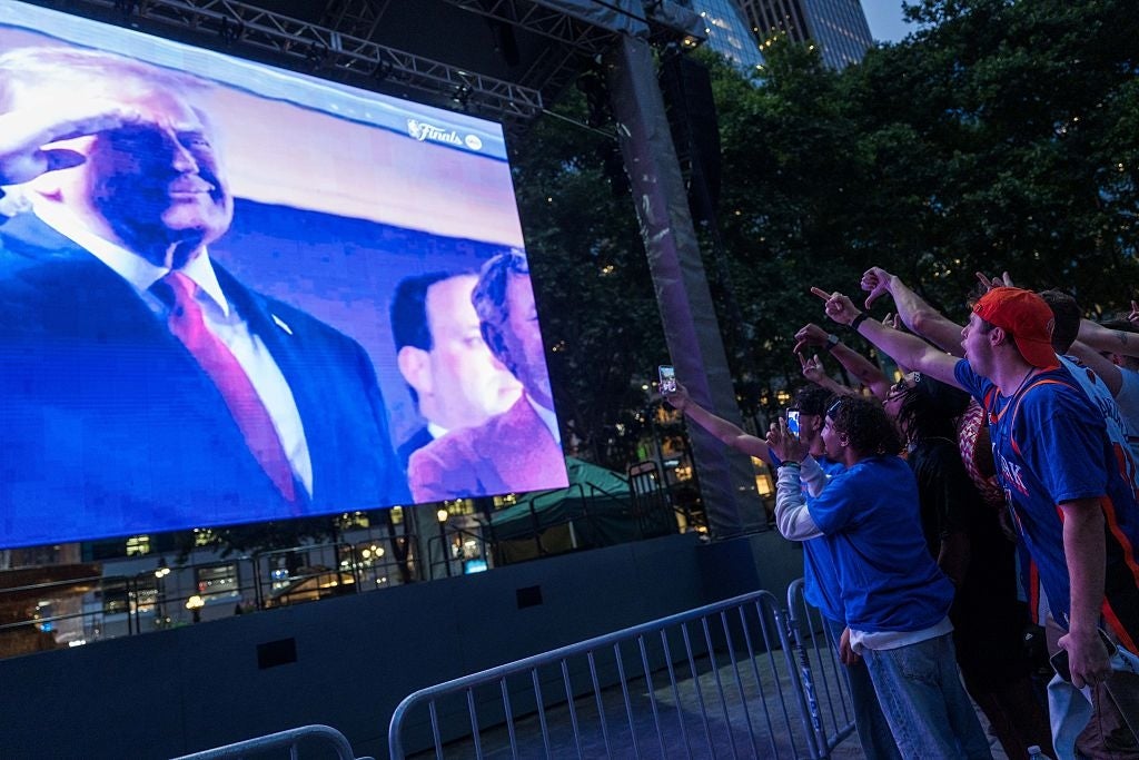 Group watching a ample outdoor surface displaying a well-dressed fig connected stage. Audience members constituent and instrumentality photos enthusiastically
