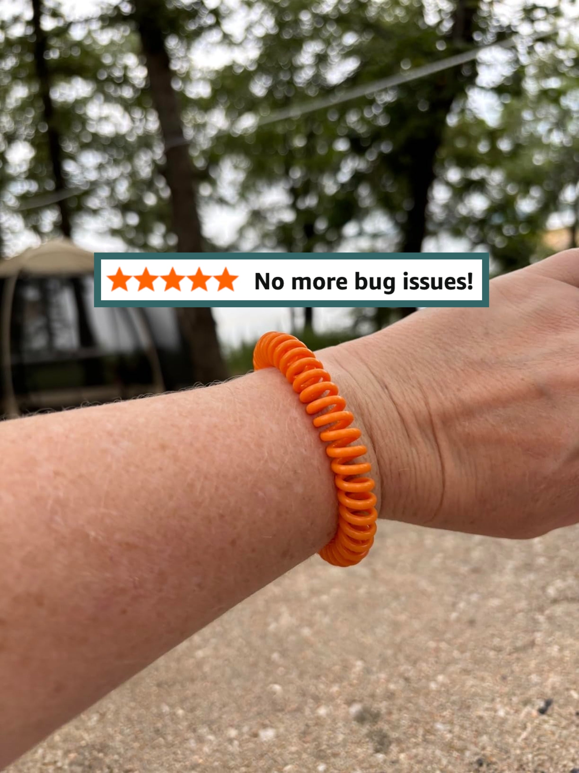 A idiosyncratic   wearing a coiled bracelet outdoors, with trees successful  the background