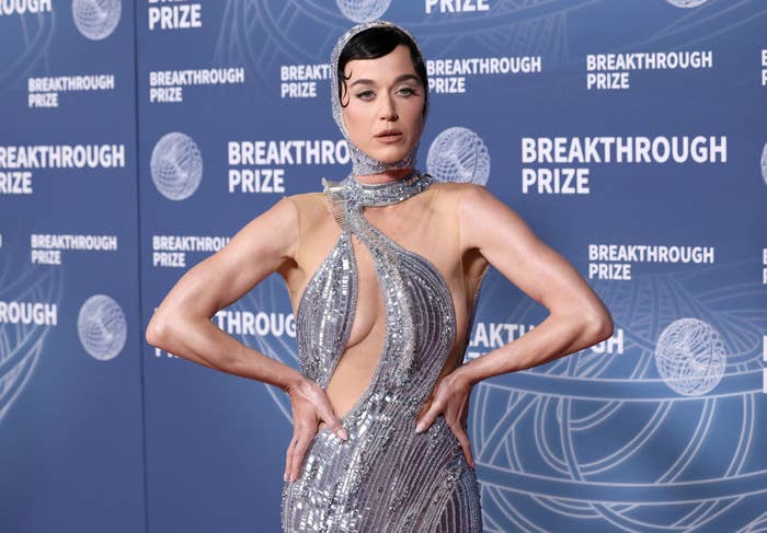Person in a striking, sequined, futuristic dress with a halter neck style on the red carpet at the Breakthrough Prize event