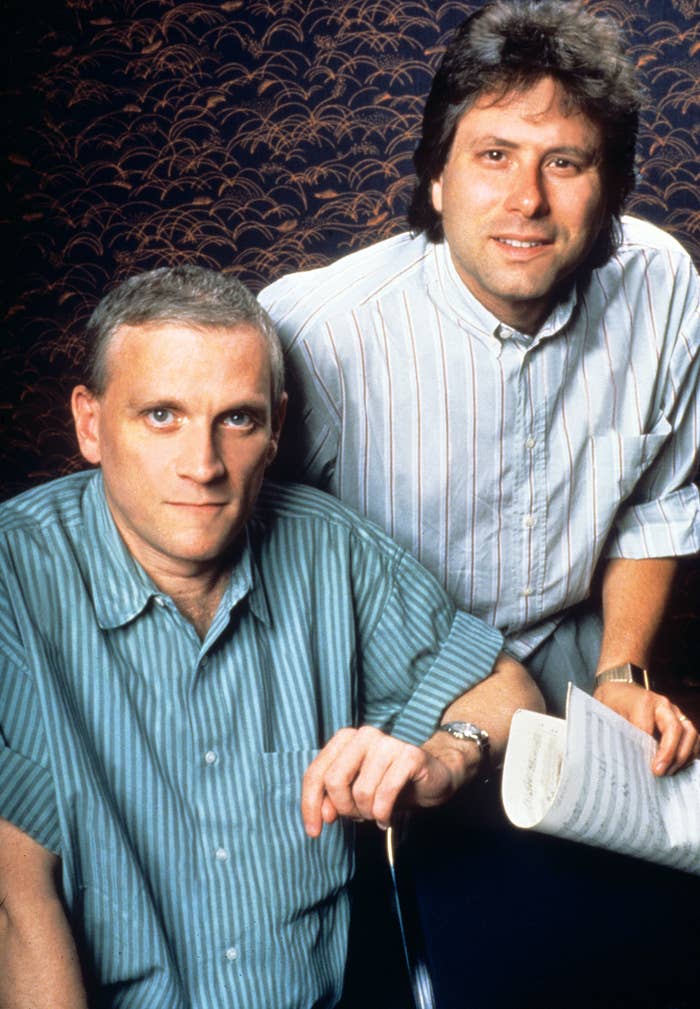 Two radical   successful  striped shirts, 1  holding sheets of music, posed against a patterned background