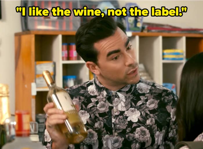 Person holding a vino  bottle, wearing a floral-patterned shirt, engaging successful  speech  wrong  a store