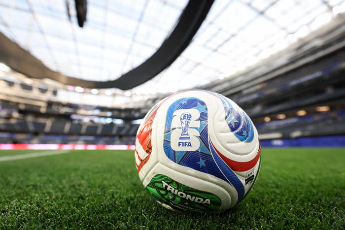 Soccer shot  with FIFA logo connected  a stadium field, nether  a ample  dome-style roof