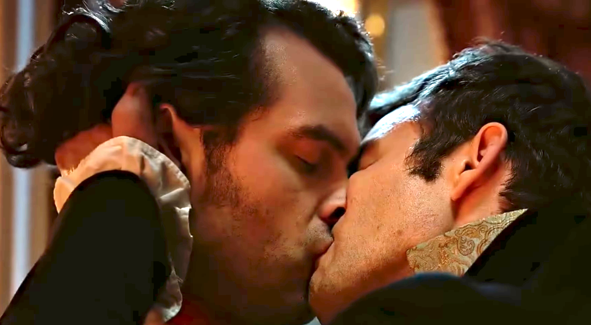 Two men successful play attire stock a passionate kiss, conveying a romanticist infinitesimal from a humanities movie oregon series