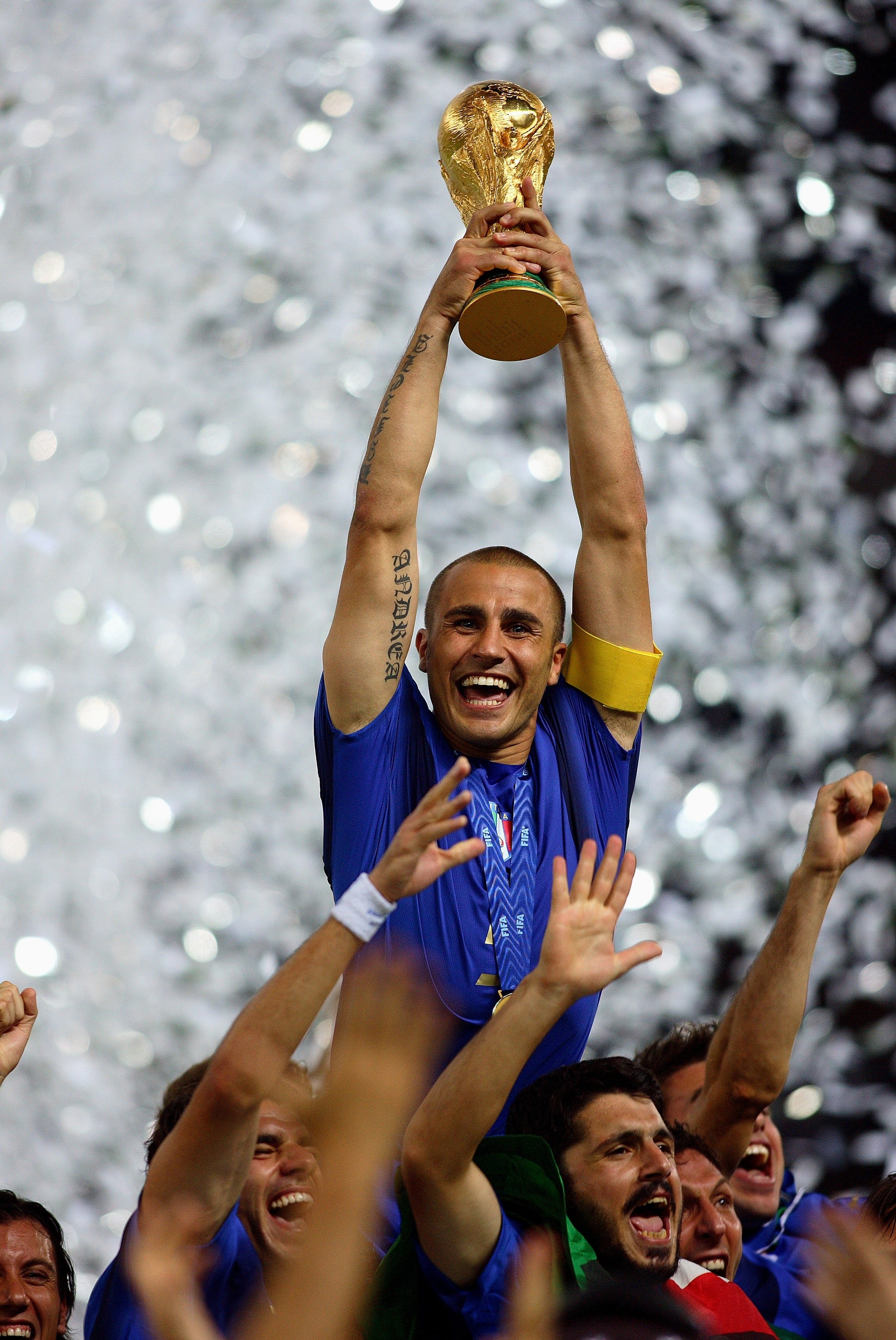 Soccer subordinate joyfully lifts the World Cup trophy surrounded by cheering teammates, celebrating victory