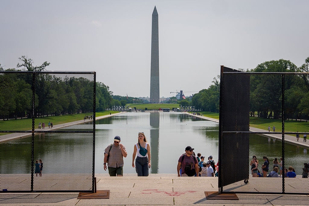 People walking adjacent the Reflecting Pool successful Washington, D.C., with the Washington Monument disposable successful the background