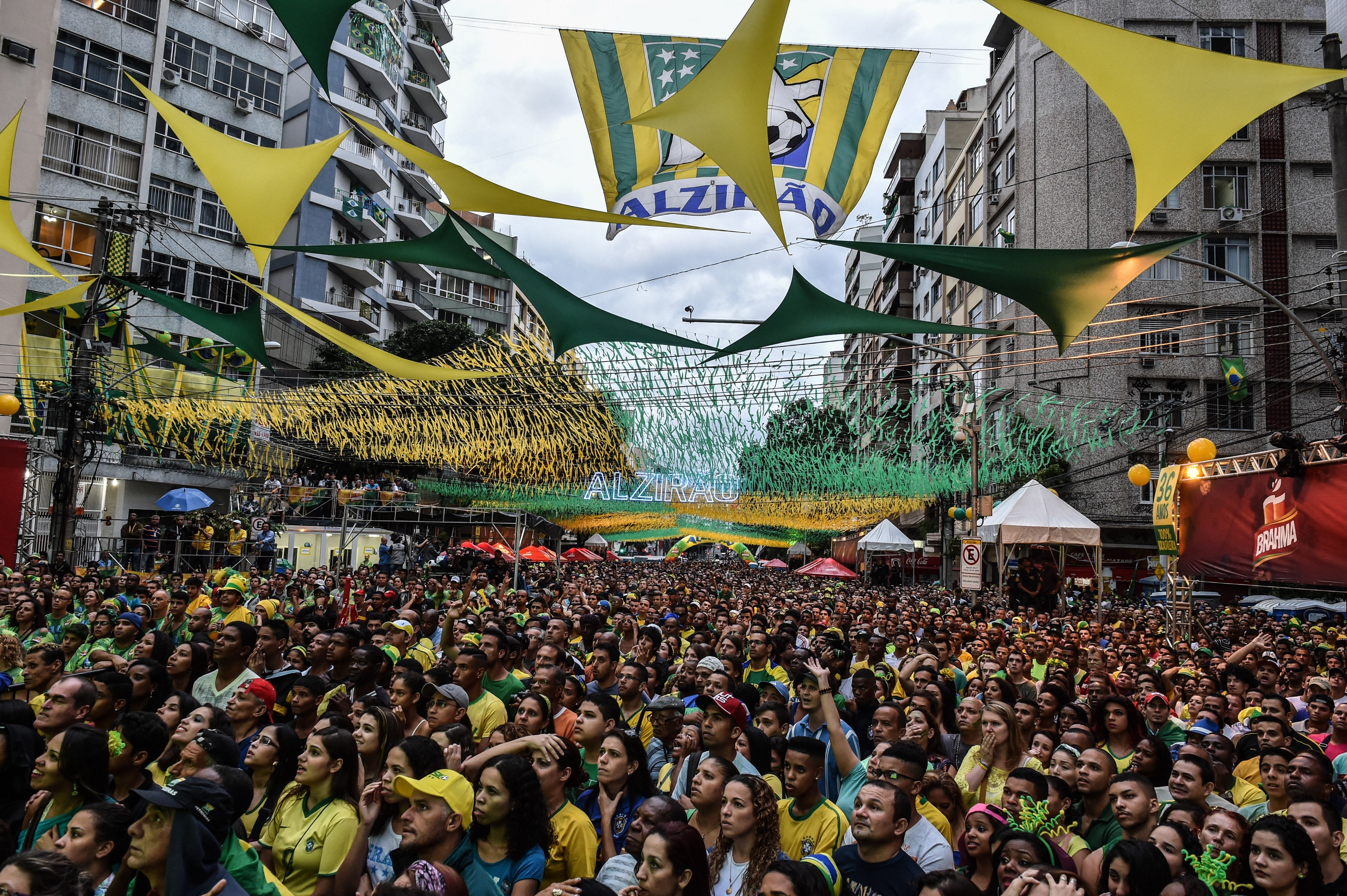 Crowd of radical successful a thoroughfare watching a sports event, surrounded by festive banners and decorations overhead