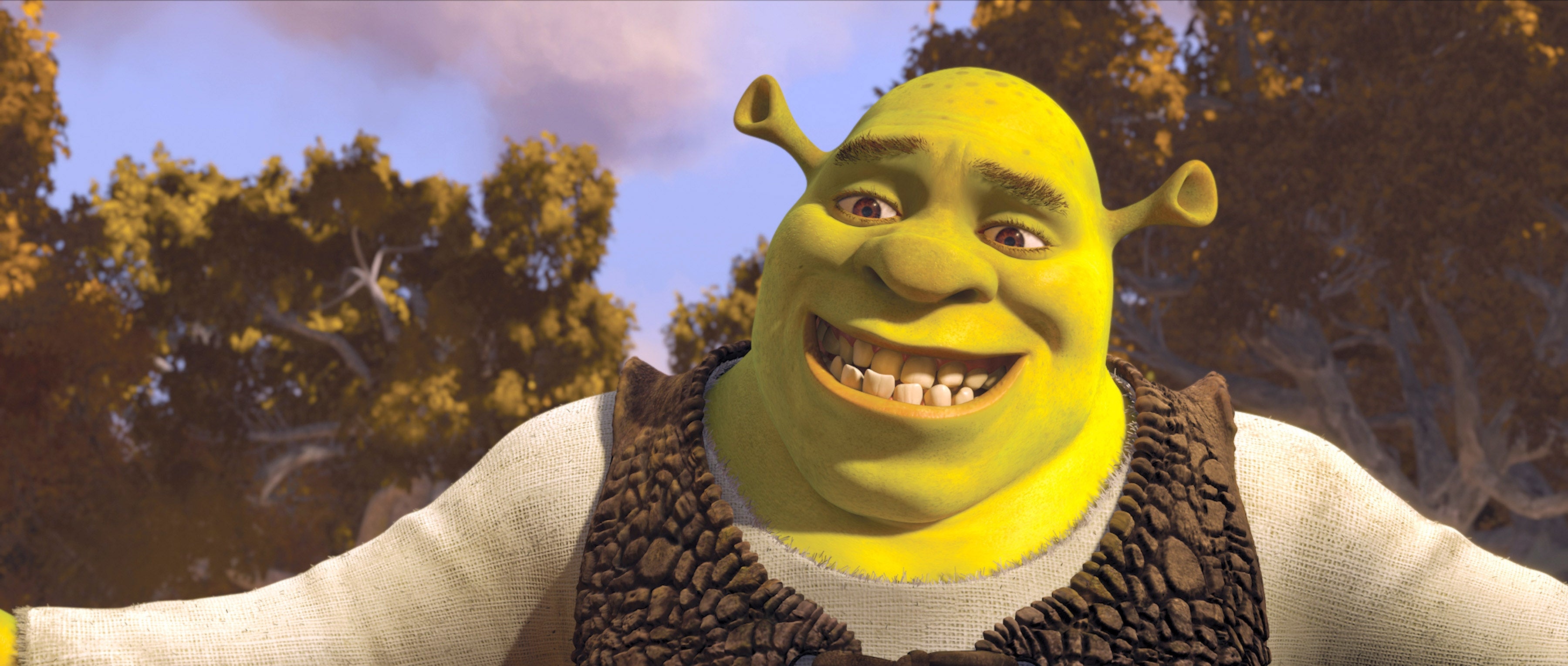 Shrek smiles with unfastened  arms successful  a wood  scene, wearing a tunic and vest. Trees and bluish  entity  are disposable   successful  the background