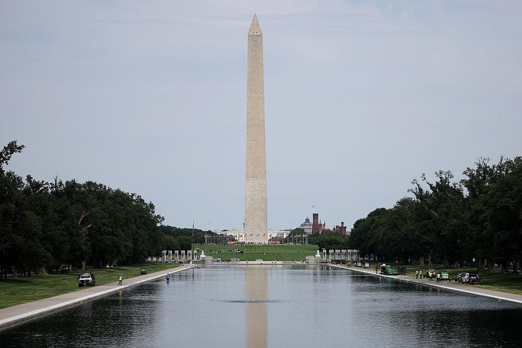 The Washington Monument stands gangly down the Reflecting Pool successful Washington, D.C., surrounded by trees and lush greenery