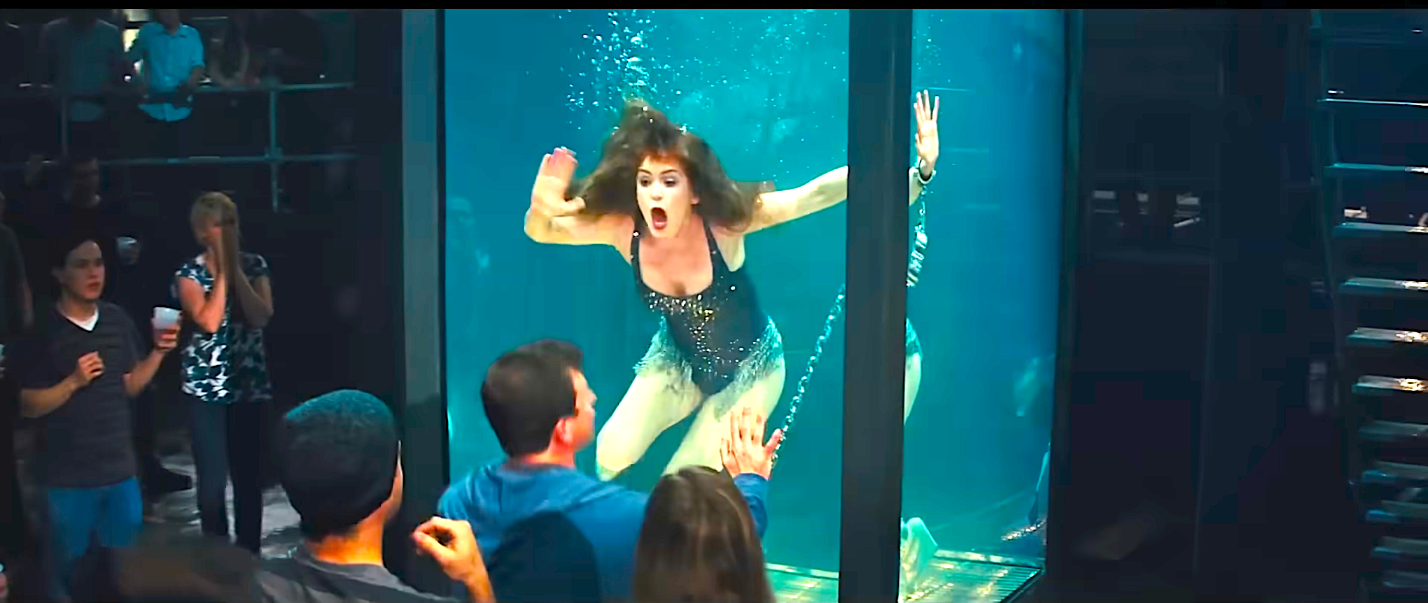 Isla Fisher in a tank performing an underwater escape act as she drowns and a crowd watches in suspense