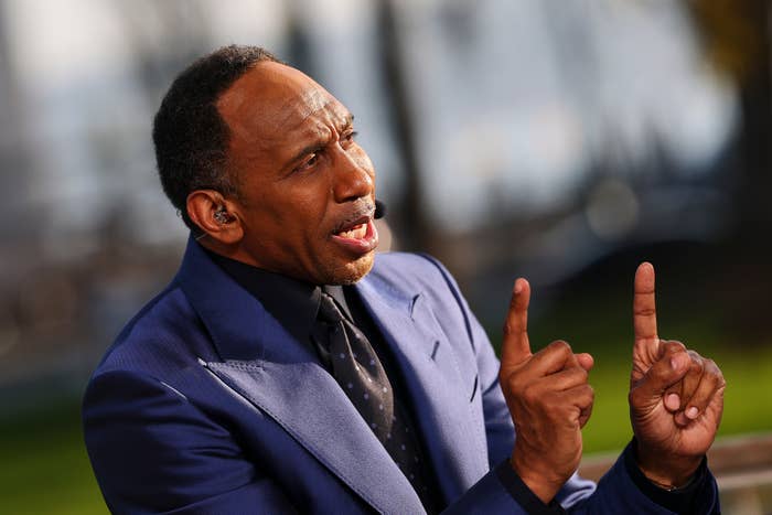 A idiosyncratic   successful  a suit   gestures with some  scale  fingers raised, appearing to talk  energetically, apt  during an interrogation  oregon  broadcast