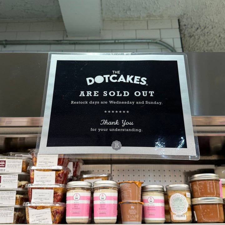 Sign on a shelf reads: "The dotcakes are sold out. Restock days are Wednesday and Sunday. Thank you for your understanding."