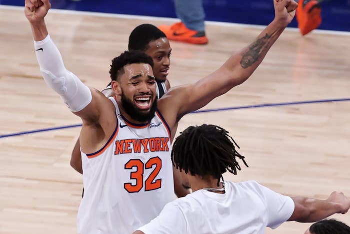 Basketball subordinate    successful  jersey fig   32 celebrates connected  tribunal  with teammates, showing excitement and joy